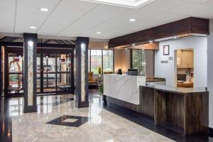 a lobby with a reception desk in a building at Clarion Suites Duluth I-85 in Duluth