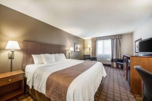 a hotel room with a large bed and a television at Quality Inn & Suites Newberry in Newberry