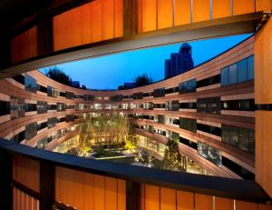 a view of a building from a window at HUALUXE Shanghai Twelve At Hengshan, an IHG Hotel in Shanghai