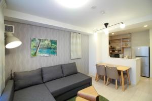 a living room with a couch and a table at W&M House in Kanazawa