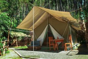 a large tent with a table and chairs in it at Ella Glamping in Ella
