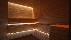 a wooden sauna with a light in the middle at Hotel Olea in Novalja