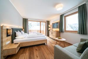 Postel nebo postele na pokoji v ubytování Hotel Trattlerhof
