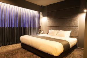 a bedroom with a large bed and a large window at Hotel Banister Kyoto in Kyoto +42 photos