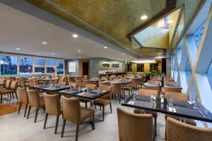 a restaurant with tables and chairs in a room at Ramada Hong Kong Harbour View in Hong Kong