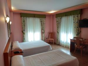 Postel nebo postele na pokoji v ubytování Hotel Real de Castilla