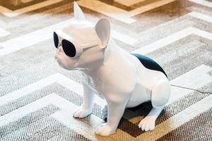 a toy dog with sunglasses sitting on the floor at SHIBUYA STREAM HOTEL formerly Shibuya Stream Excel Hotel Tokyu in Tokyo