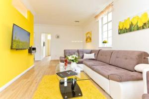 a living room with a couch and a table at Villa Livia Whg 01 in Ahlbeck