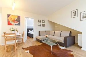 a living room with a couch and a table at Villa Livia Whg 05 in Ahlbeck