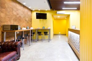a waiting room with a bar and a yellow wall at City Star in Moscow