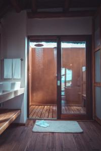 a room with a sliding glass door with a rug at Eclectic Beach Retreat in Cabo Nhamua