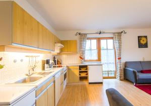 a kitchen with a sink and a couch in a room at Appartement Achenhof in Bad Hofgastein