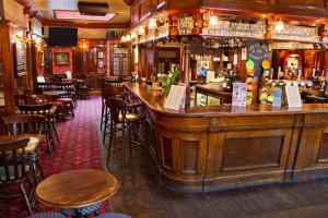 a bar in a pub with wooden tables and chairs at The Market Inn in Brighton & Hove