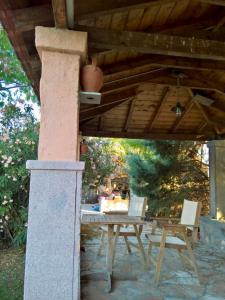 a patio with a table and chairs under a wooden roof at Marita in Lisvórion