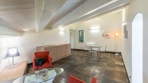 a living room with a table and chairs at Scicli Albergo Diffuso in Scicli