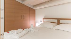 a bedroom with a bed with towels on it at Scicli Albergo Diffuso in Scicli