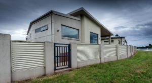 a house with a fence in front of it at Leven River Retreat in Ulverstone