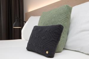 Tempat tidur dalam kamar di Businesshotel Forum Widnau