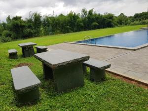 a group of picnic tables and a swimming pool at PrimeBiz Hotel Karawang in Cikampek +20 photos