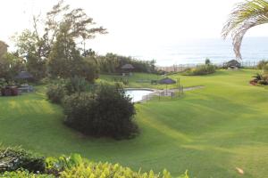 a view of a golf course with the ocean in the background at Our Happy Place in Durban