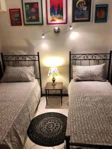a bedroom with two beds and a table with a lamp at Romantic Venice in Venice