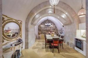 a kitchen and dining room with a table and a mirror at Western Wall Luxury House - Avraham in Jerusalem