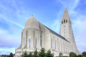 a church with a steeple and a clock tower at Central Reykjavík - Garden Cottage in Reykjavík