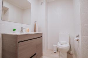 a bathroom with a toilet and a sink and a mirror at Funchal City Apartments in Funchal +21 photos