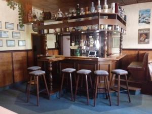 a bar in a room with stools around it at Gasthof Jacobshöhe in Kloster GrÃ¶ningen