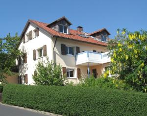 a large white house with a red roof at Haus Holzheimer in Bad Kissingen