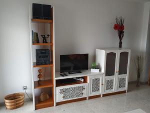 a white entertainment center with a flat screen tv at Piso JMAM Centro in Puerto del Rosario