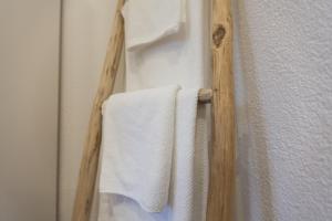 a towel rack with two towels hanging on a wall at Dorf Alm Ferienwohnung in Schwalmtal