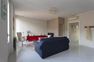 a living room with a blue couch and a red table at Casa ALBERTINI in Como