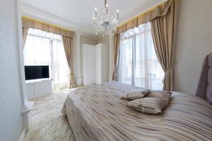 a bedroom with a large bed with two pillows on it at Harmony Suites - Monte Carlo in Sunny Beach