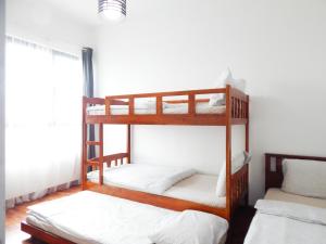 two bunk beds in a room with a window at Wadi Iman Suites @ i-City in Shah Alam