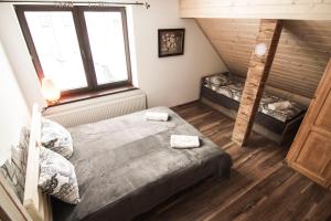 Posteľ alebo postele v izbe v ubytovaní Osada Koniaków