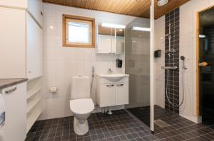 a bathroom with a toilet and a sink and a shower at Holiday Club Kuusamon Tropiikki in Kuusamo