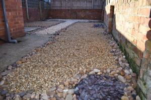 a garden with rocks and a brick wall at Seventy Seven in Gainsborough