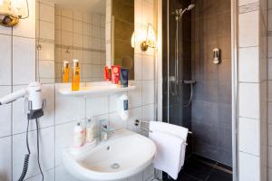 a bathroom with a sink and a shower at Pension Domblick in Wetzlar