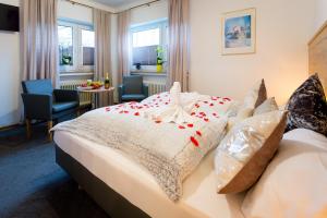 a hotel room with a bed with red hearts on it at Pension Domblick in Wetzlar