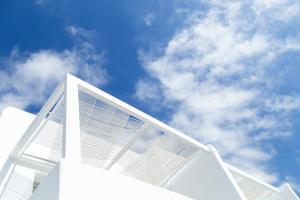a white building with the sky in the background at Nimbus Mykonos in Agios Stefanos