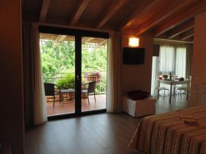a bedroom with a bed and a sliding glass door at Cà dell'Orto Rooms & Apartments in Verona