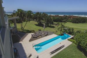 an overhead view of a swimming pool and the ocean at 11 on Fairway Beach Villa in Southbroom