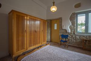 A bed or beds in a room at Iliopetra House