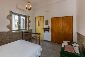 A bed or beds in a room at Iliopetra House