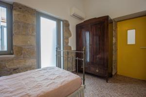 A bed or beds in a room at Iliopetra House