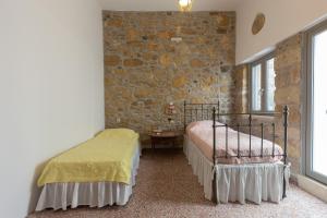 A bed or beds in a room at Iliopetra House