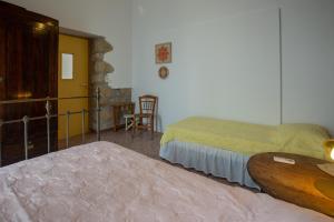 A bed or beds in a room at Iliopetra House