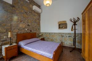 A bed or beds in a room at Iliopetra House