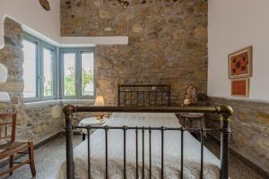 A bed or beds in a room at Iliopetra House